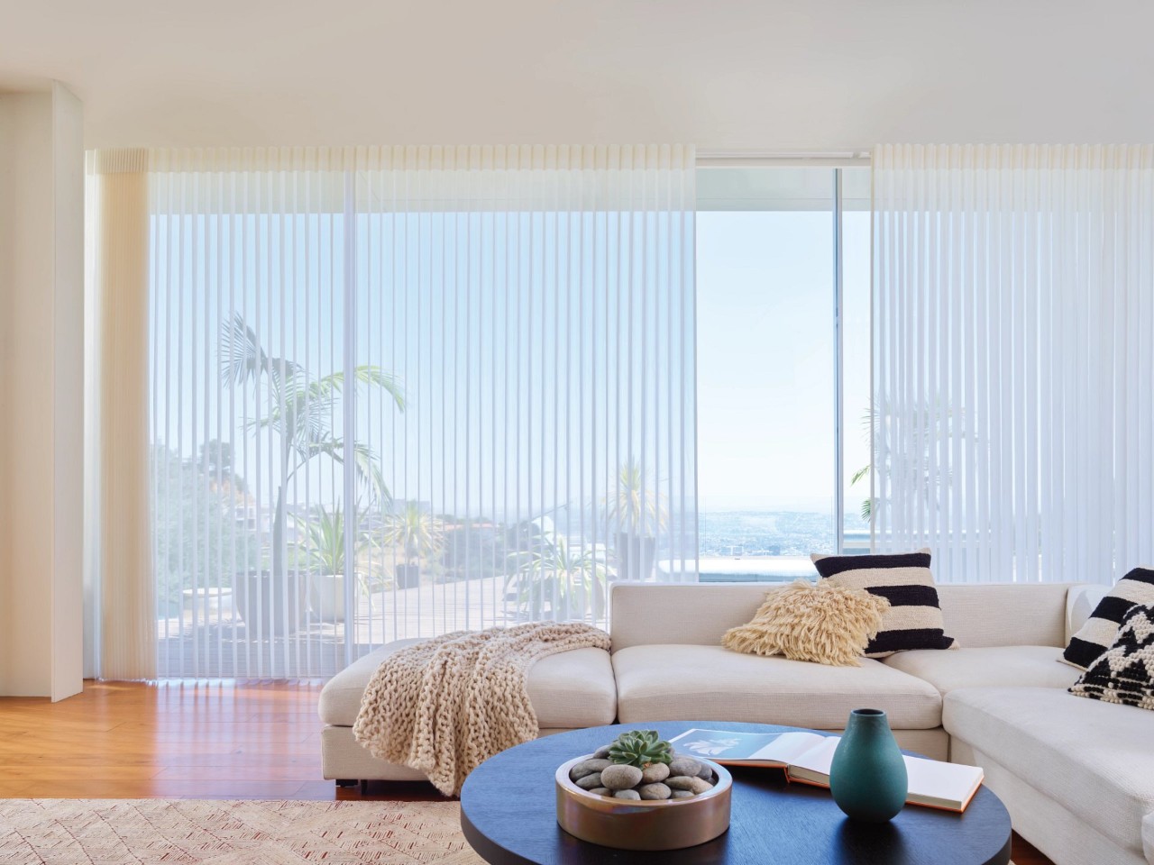 A white couch by a wooden table with beautiful drapes in the windows near Concord, California (CA)